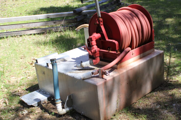 Fire brush rig water tank and hose reel