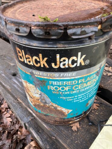 Partial bucket of roofing tar